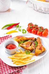 Grilled chicken wings,legs,chips and vegetables