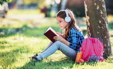 Schoolgirl reading a book. Education, lifestyle concept