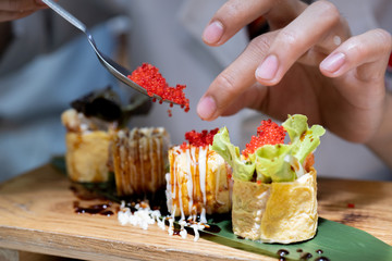Closeup of chef hands preparing japanese food.