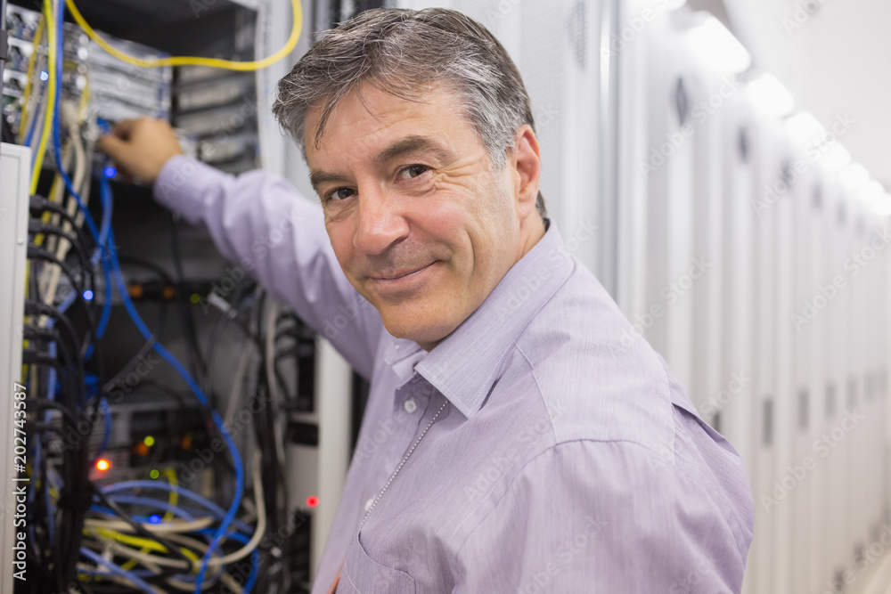 Poster technician changing cables in the server case