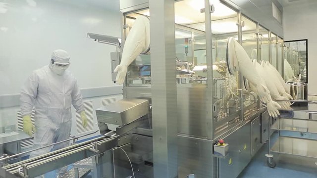 Pharmaceutics. Pharmaceutical worker operates blister packaging machine. Quality control. Pharmaceutics. Worker operator portrait