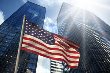 USA national flag against low angle view of skyscrapers