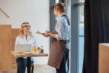 Nice friendly waitress taking an order