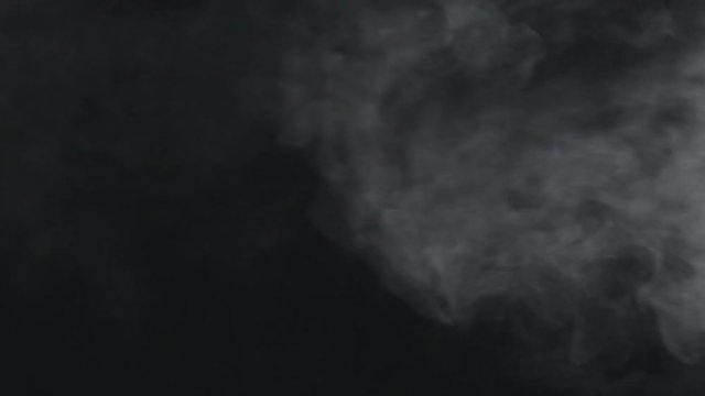 slow motion vapor steam from right side over black background