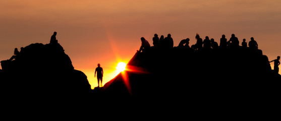 Fototapeta premium Silhouetted Crowd Gathered at Sunset