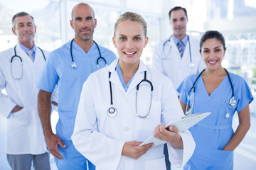 Team of smiling doctors looking at camera