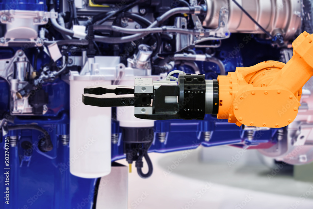 Aufkleber robot on the assembly of engines on the conveyor