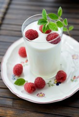 Yogurt with fresh berries on dark background