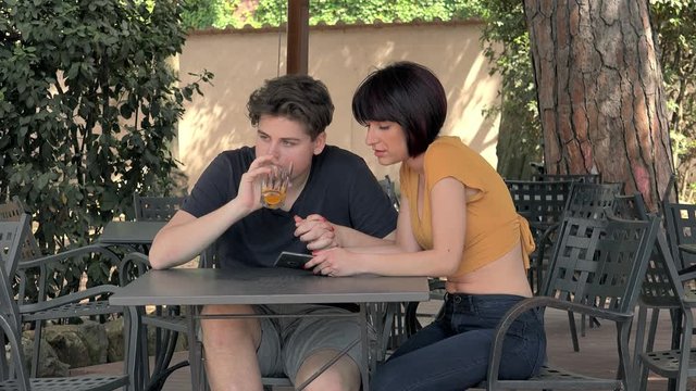 Young woman gets angry with her boyfriend at the bar: jealousy, anger