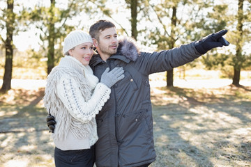Loving young couple in winter clothing in the woods