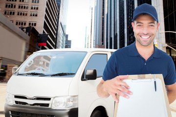 Fototapeta premium Happy delivery man with package and clipboard against new york street
