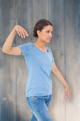 Powerless brunette against bleached wooden planks background