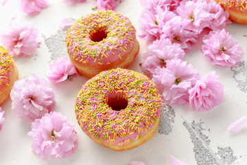 Sweet pink fresh Donut decorated with japanese Flowering Cherry Tree flower