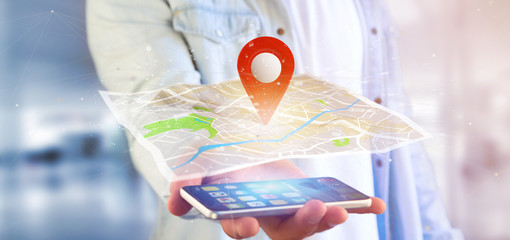 Man holding a 3d rendering pin holder on a map