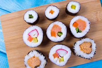 Various kinds of sushi on the blue background.