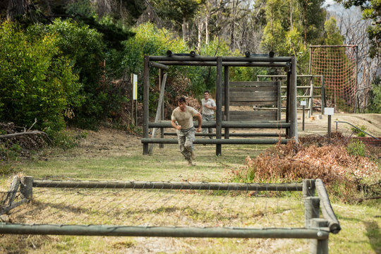 Soldier running through obstacle course