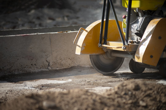 Workers Control Concrete Cutter.