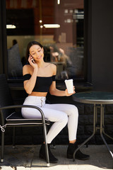 Girl with phone and coffee cup