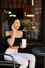 Girl with phone and coffee cup