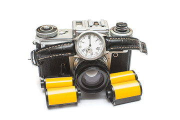 Creative retro concept from the past. Old retro film camera and photo film roll with mechanical...