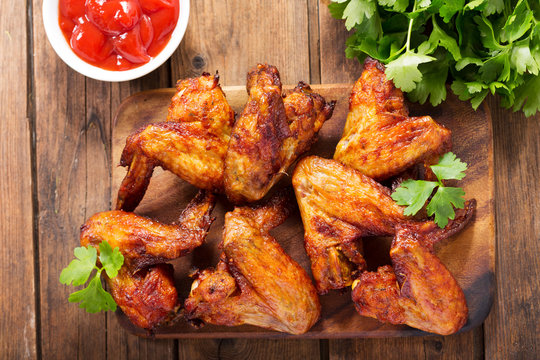 baked chicken wings on wooden table
