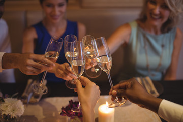 Friends toasting champagne glasses in restaurant