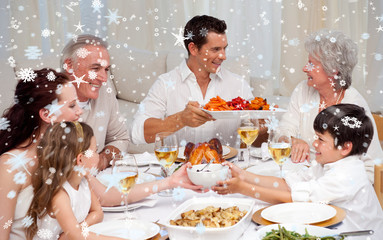 Composite image of Family having a big dinner at home against snow