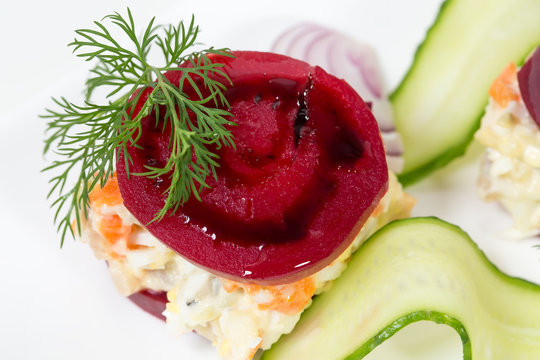 Traditional herring salad with beets and onions.