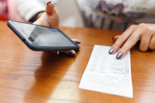 Woman Check The Bill By Using A Mobile Phone Calculator