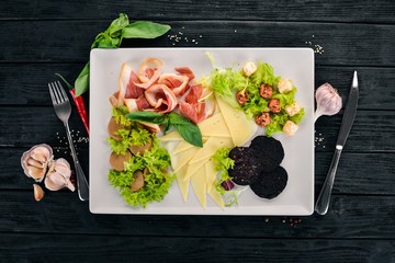 Cold snacks. Bacon, Cheese, Liver Paste. Top view. On a wooden background. Copy space.