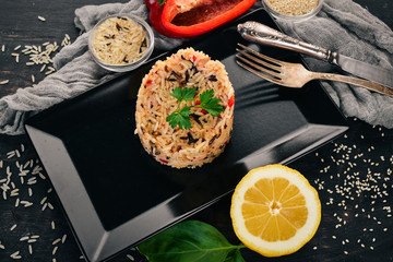 Risotto with vegetables. On a wooden background. Top view. Copy space.