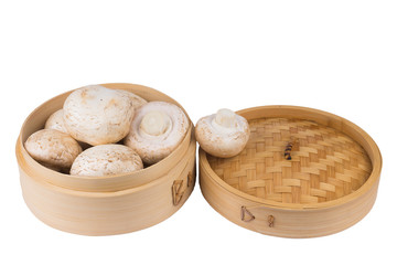 White mushrooms in a bamboo container. Isolate on white background.