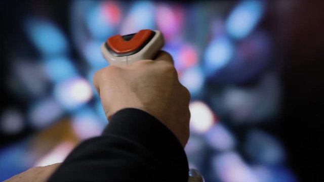Playing with a retro vintage joystick (input device for computer games) with a shooting video game: ready player one, fighting ships, firing a lot, then a Game Over screen appears.
