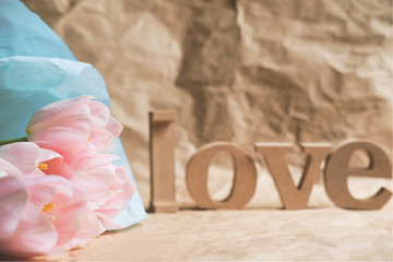 Bouquet of pink tulips and Wooden letters word 
