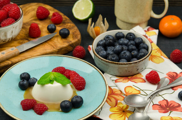 Tasty Panna Cotta with fresh fruits and caramel sauce