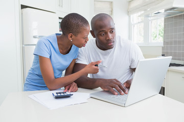 Happy couple working and using laptop