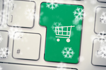 Snowflakes against green trolley button on keyboard