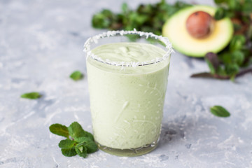 Obraz na płótnie Canvas Healthy green milkshake or smoothie with avocado and mint