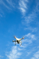  drone hovering in a bright blue sky. New technology in the aero photo shooting.