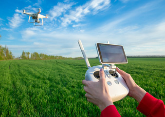 Female flying a drone at the field