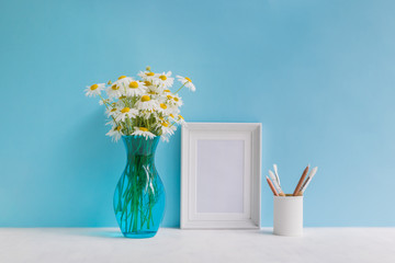 Mockup with a white frame and white daisies