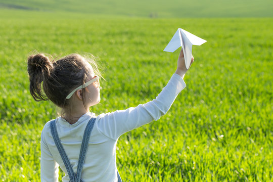 Happy Kid Playing With Paper Airplane