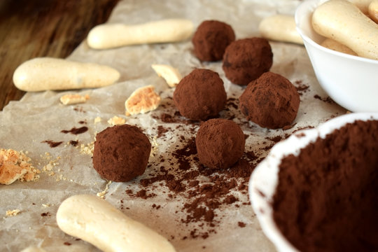 Chocolate truffles sprinkled with cocoa powder and meringues