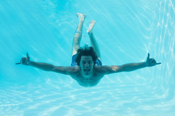 Young man swimming underwater