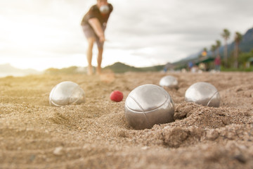 Beach. A game of Bocha. Brilliant silver balls for a bocha on the sand.