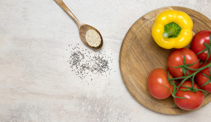 Tomatoes and yellow pepper on wood.