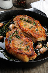 Roasted pork steak in frying pan