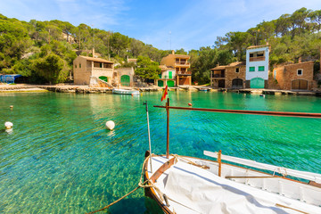 Fototapeta na wymiar Typical fishing boat anchoring in beautiful bay in Cala Figuera village, Majorca island, Spain