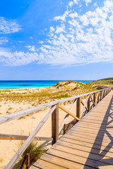 Fototapeta na wymiar Walkway on sand dunes to Cala Mesquida beach, Majorca island, Spain