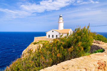 Fototapeta na wymiar Lighthouse on high cliff above sea in Cala Ratjada, Majorca island, Spain